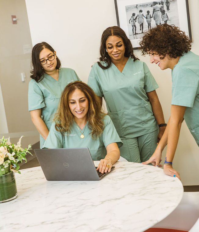 Dr. Elassar working with members of the NYC IVF team around a table in the office
