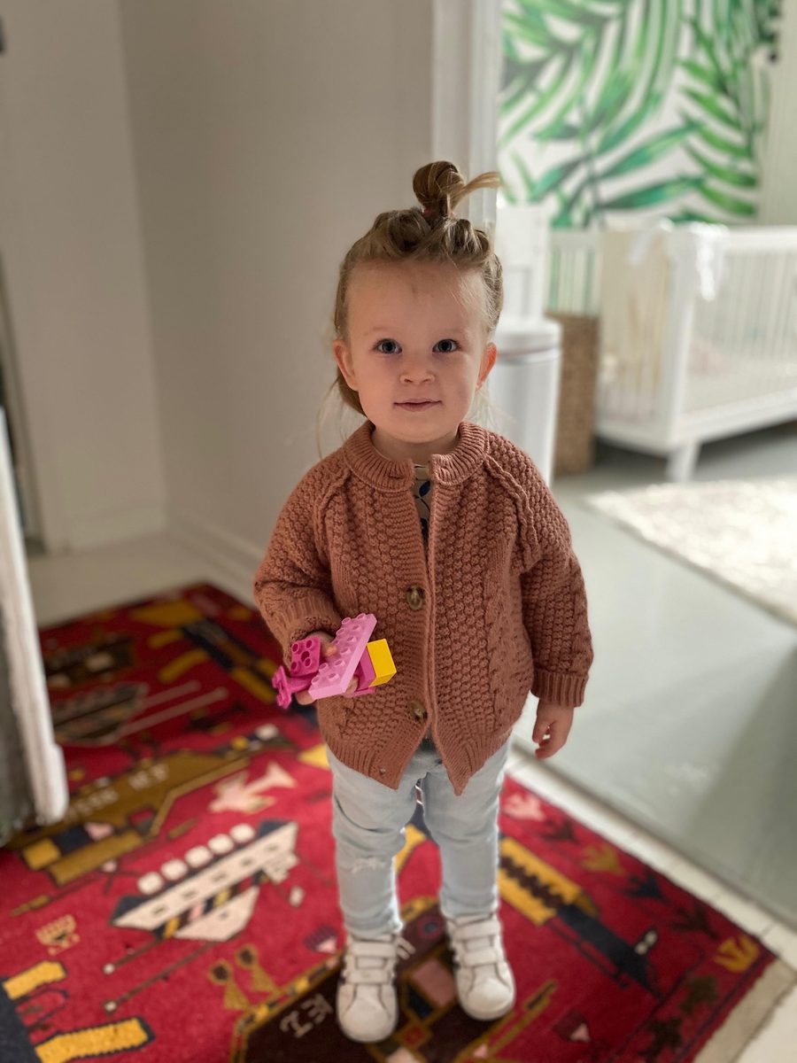 A toddler standing in a bright room