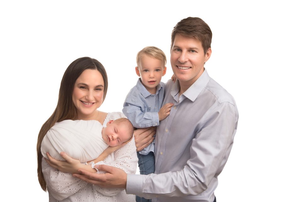 A family of four smiling together