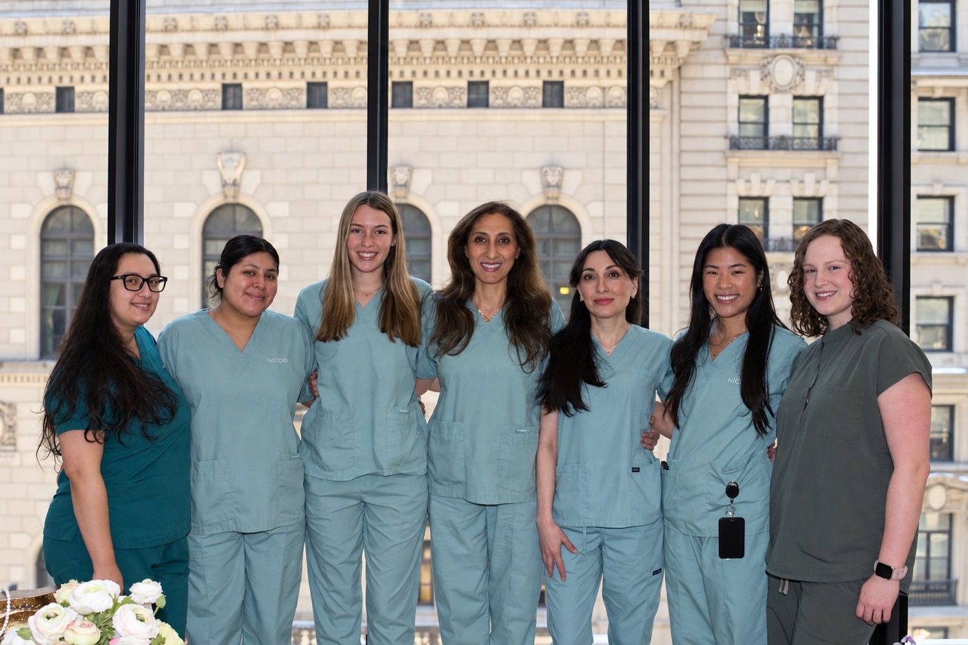 The NYC IVF team together at the windows of the Fifth Avenue office