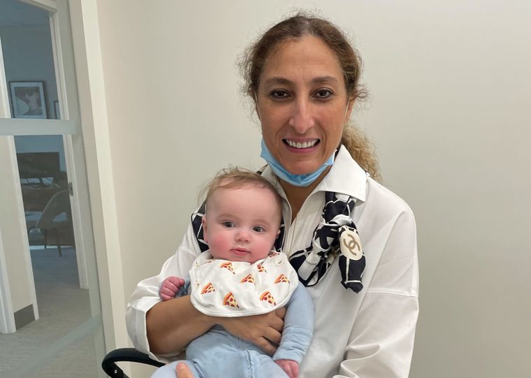 Dr. Elassar holding a baby boy