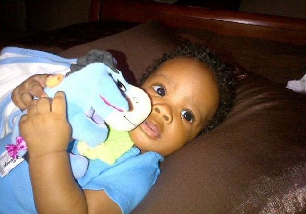 A baby holding a blue blanket