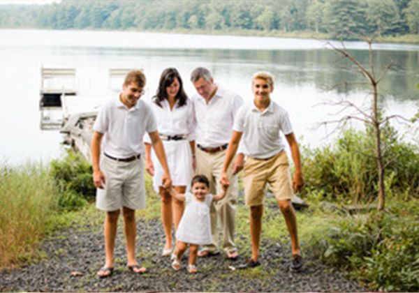 A family of six by a lake