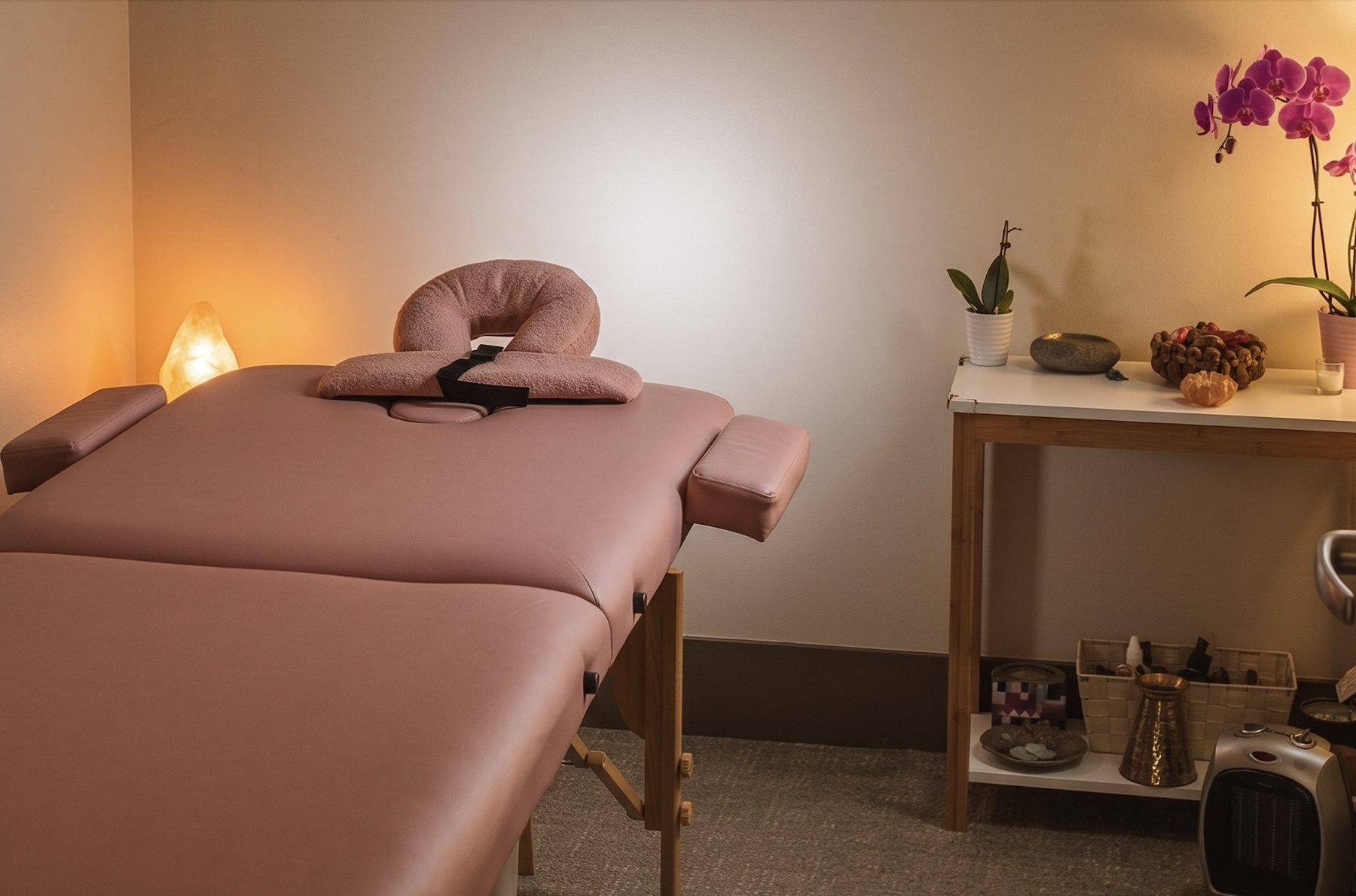 The wellness room at NYC IVF, with a massage table, a salt lamp and orchids